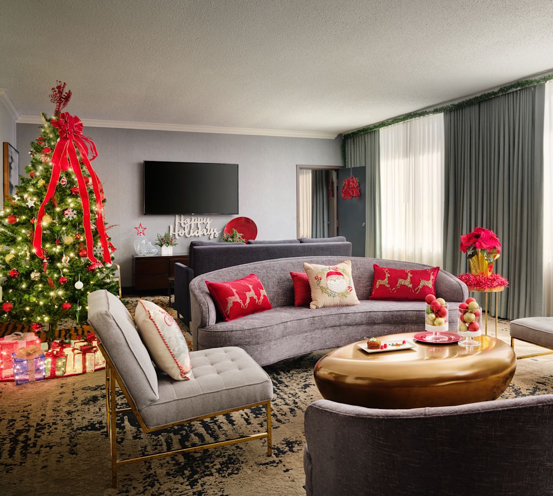 Lounge area in guest room with festive decorations including Christmas tree-transition