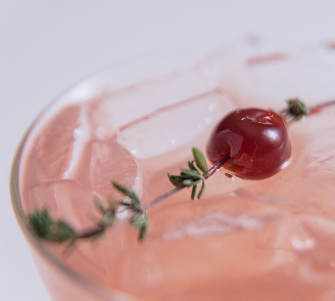 Close-up of drink, with ice and cherry