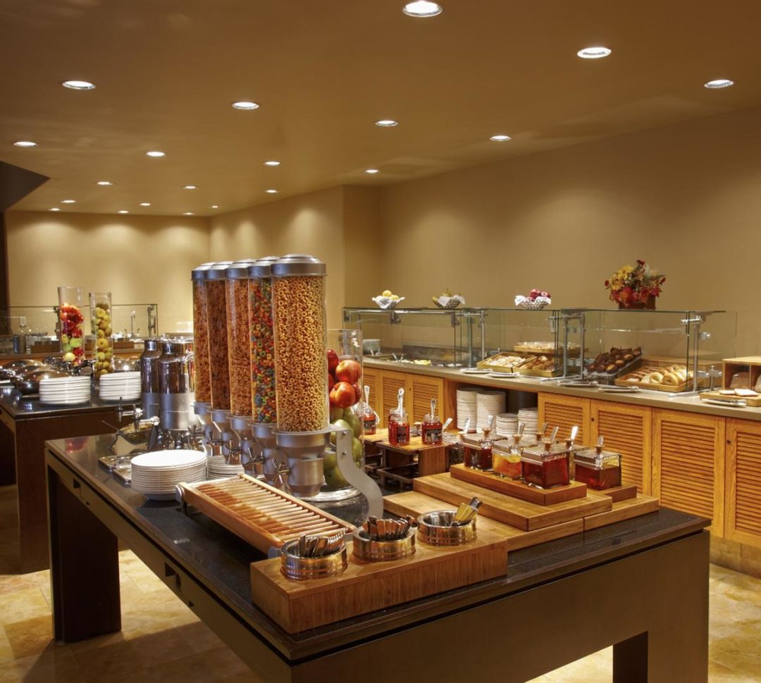 Interior of Sundance Cafe. A breakfast buffet with cereal, fruit, and pastries is set up.-transition