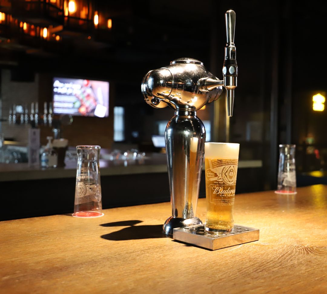 Closeup of a beer tap with a full pint of larger