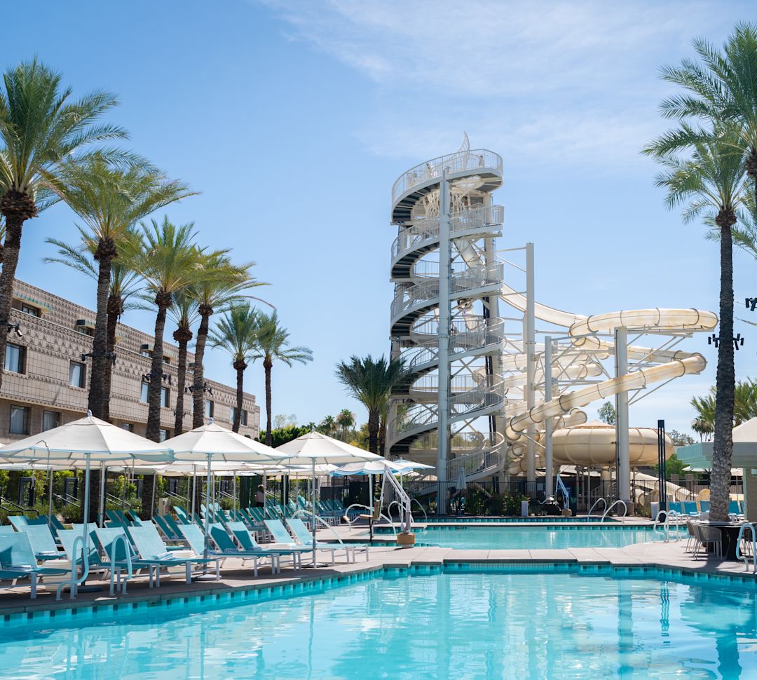 View of pool, with loungers and slides