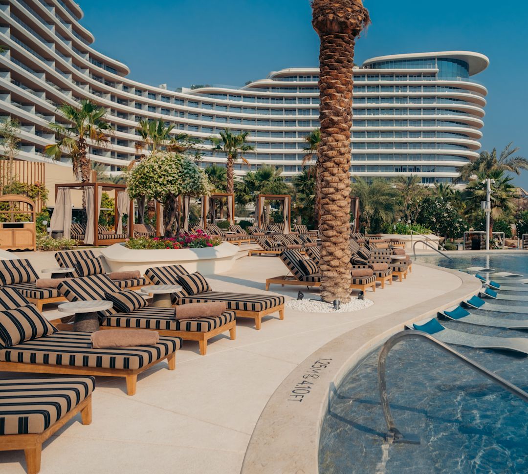 Outdoor Pool Area with  Palm Trees, Lounge Chairs and Canbanas