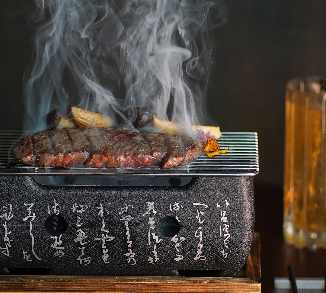 Meat being cooked on a small grill