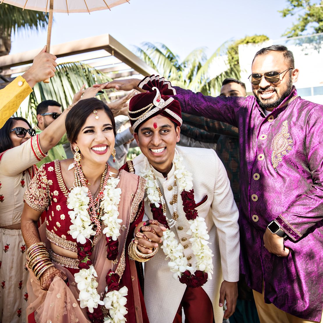 Wedding ceremony with bride and good smiling as people create arch overhead-transition