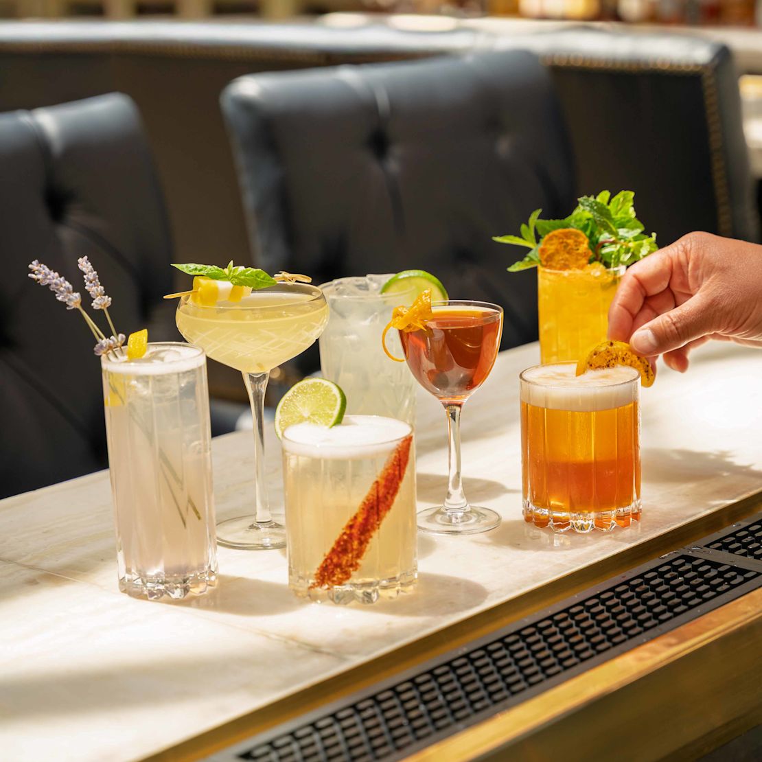 Bartender Adding Last Touches to Drinks Cocktails on a Table at Peacock Alley Restaurant-transition