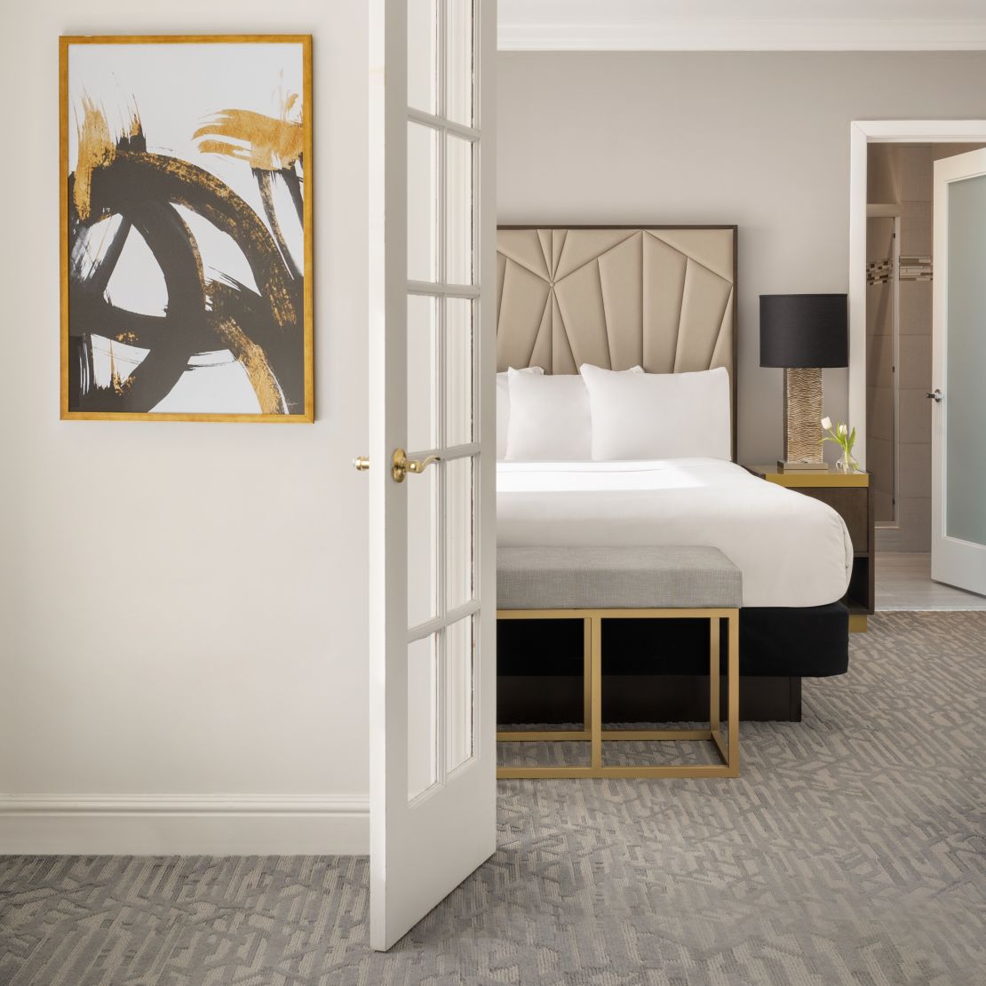 entrance to suite bedroom in neutral color palette and shot of bed-transition