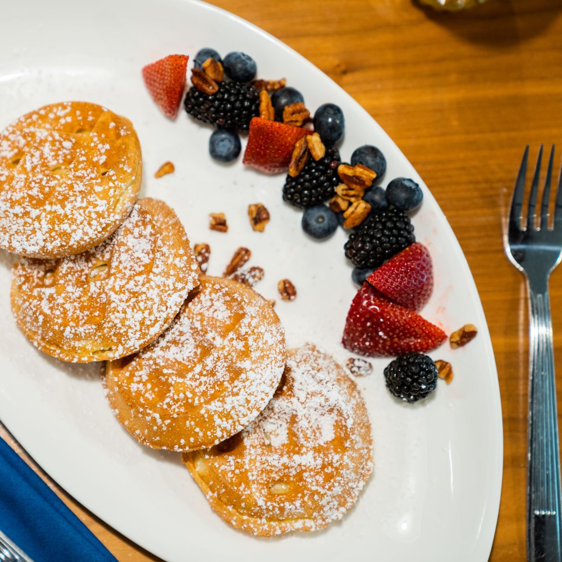 Four Oaks restaurant breakfast plate, pancakes, syrup, fruit-transition