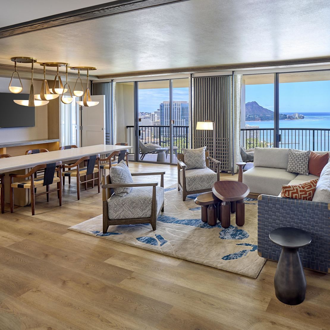 guest suite lounge area, sofa, coffee table, chairs, dining table, window views of the water-transition