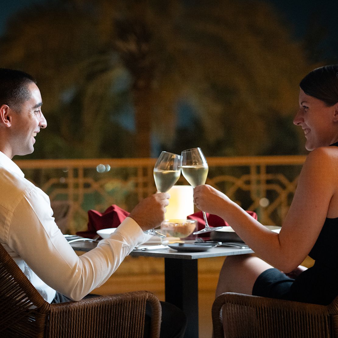 Lexington Grill & Bar area, with man and woman smiling as they raise glasses in toast-transition