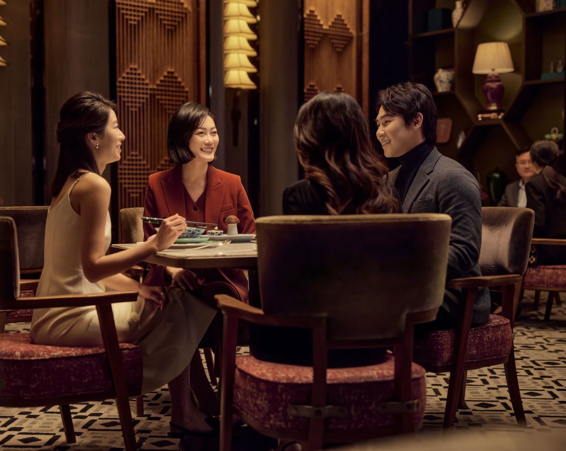 Group of people sitting in restaurant enjoying meal-transition