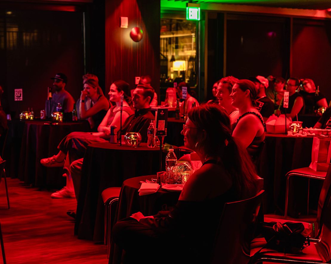 huéspedes sentados en las mesas del Bat City Comedy Club-transition