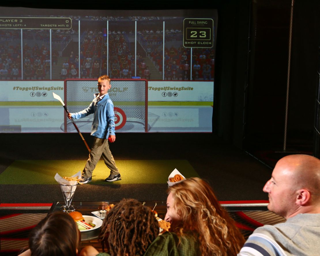 Topgolf swing suite at FastBreak, guests playing hockey-transition