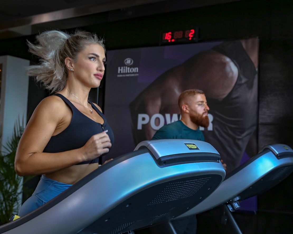 homme et femme courant sur des tapis de course dans le centre sportif-transition