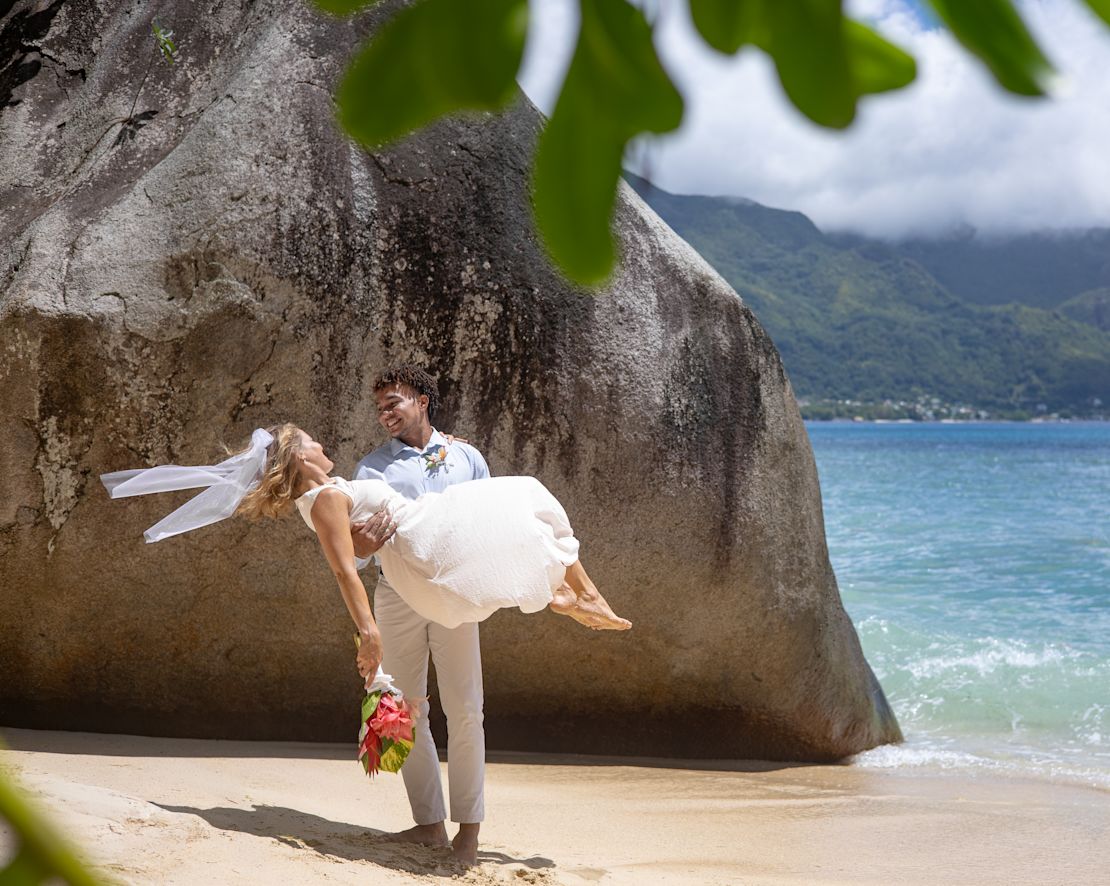 Groom Holding His Bride in His Arms at the Beach-transition