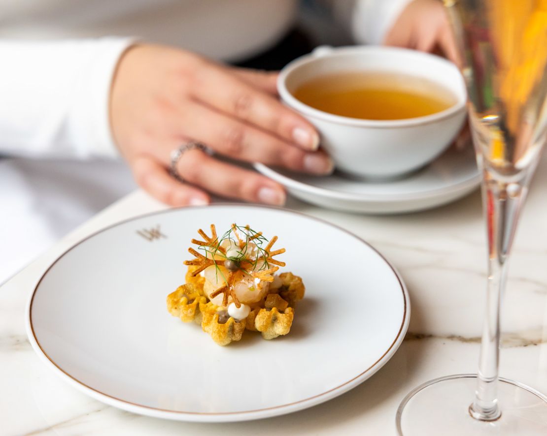 Woman Enjoying Tea Time atPeacock Alley-transition
