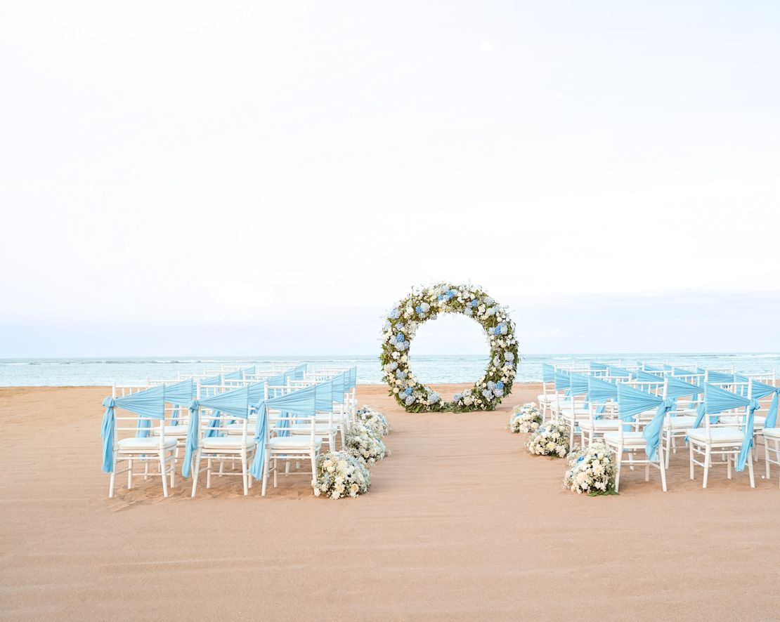 Allestimento della spiaggia con sedie e fiori per celebrare un matrimonio-transition