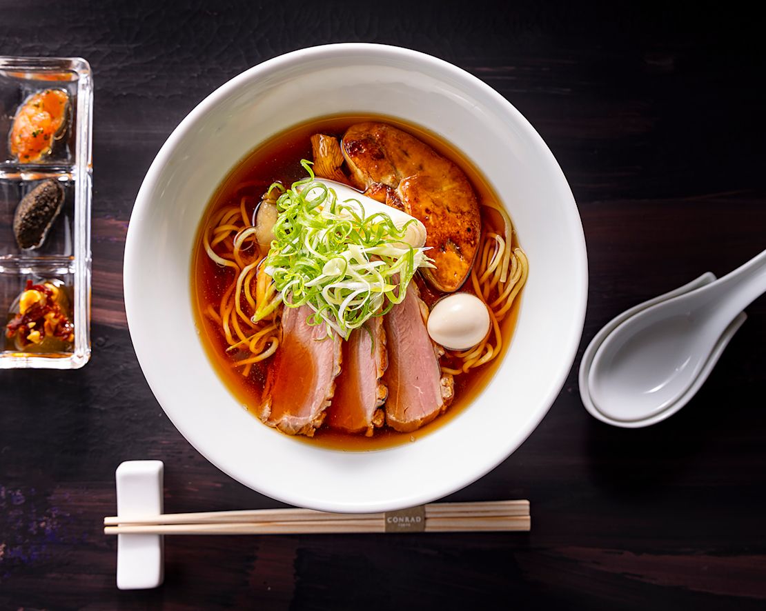 a Plate with Meat, Noodles and Sauce at Cerise Restaurant-transition