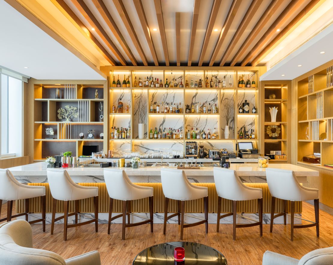 Bar in the Lounge with seating at bar and table and chairs.-transition