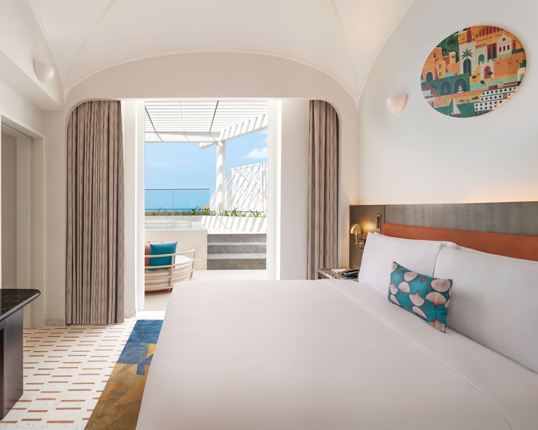 Guestroom with bed and TV-previous-transition