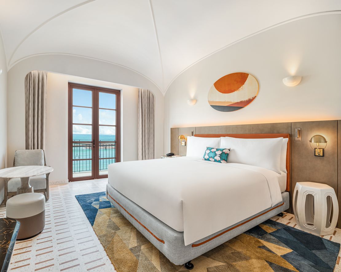 a Large Bed in a Guest Room with Ocean View from Balcony-next-transition