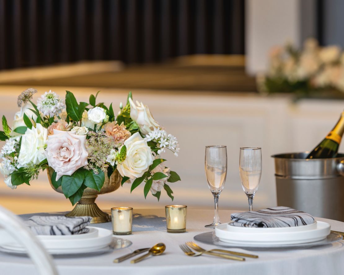 Beautiful detail of table with wedding setup, flowers and champagne.-transition