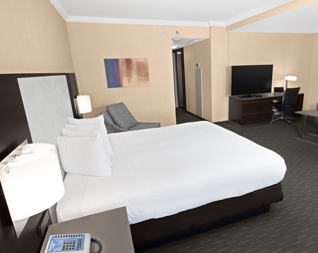 Large Bed in a Guest Room with Sofa and City View-transition