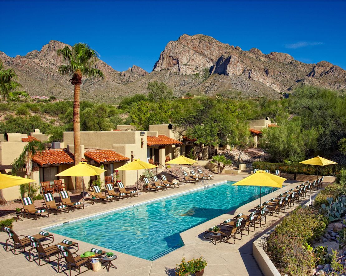 Outdoor Pool Area with Lounge Chairs and Mountains in Background-transition
