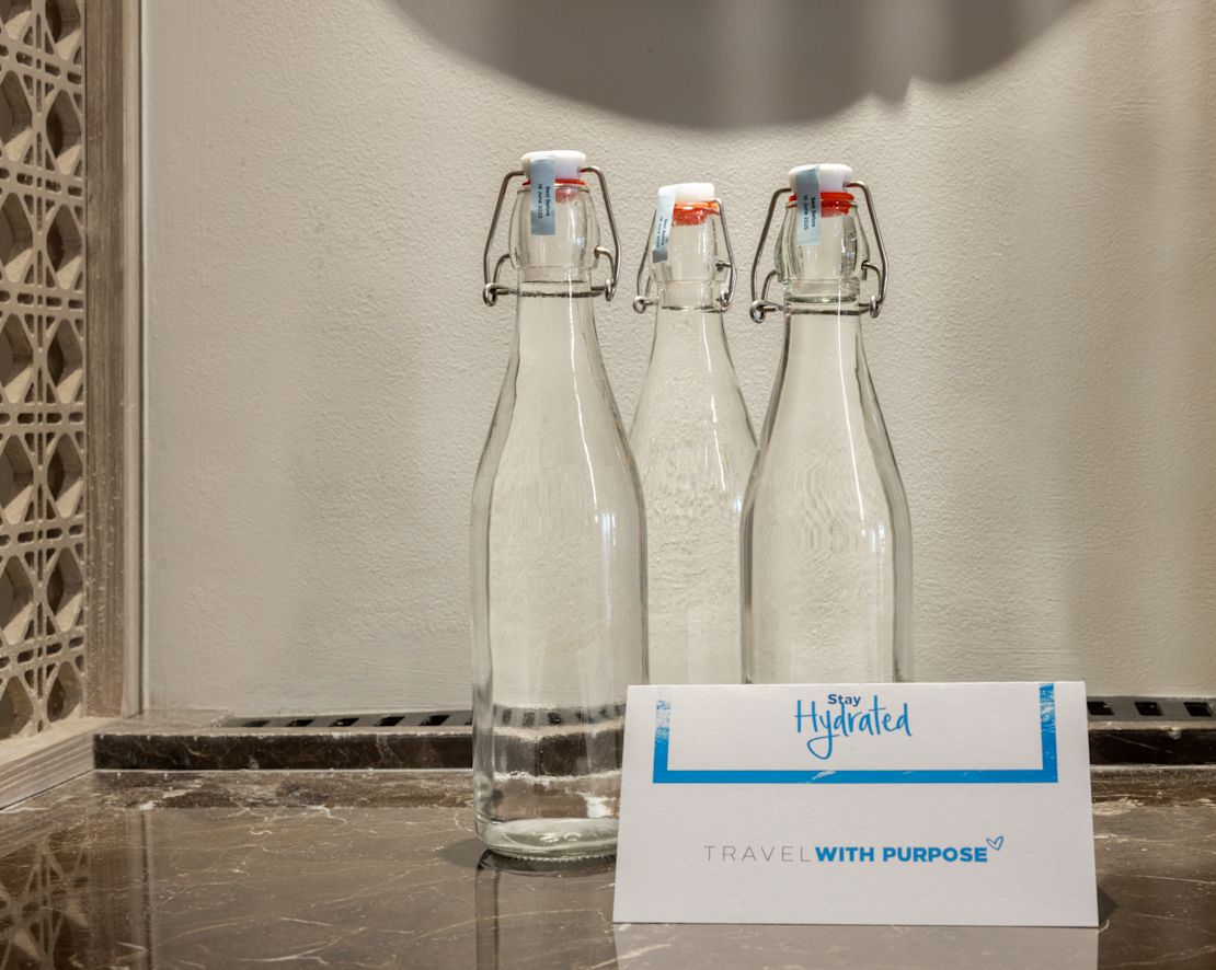 Glass bottles with hinged stopper lids for water.-transition