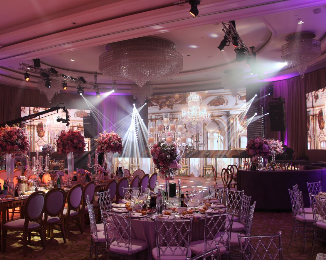 Indoor wedding venue, complete with lovely lighting and decorated rounds-transition