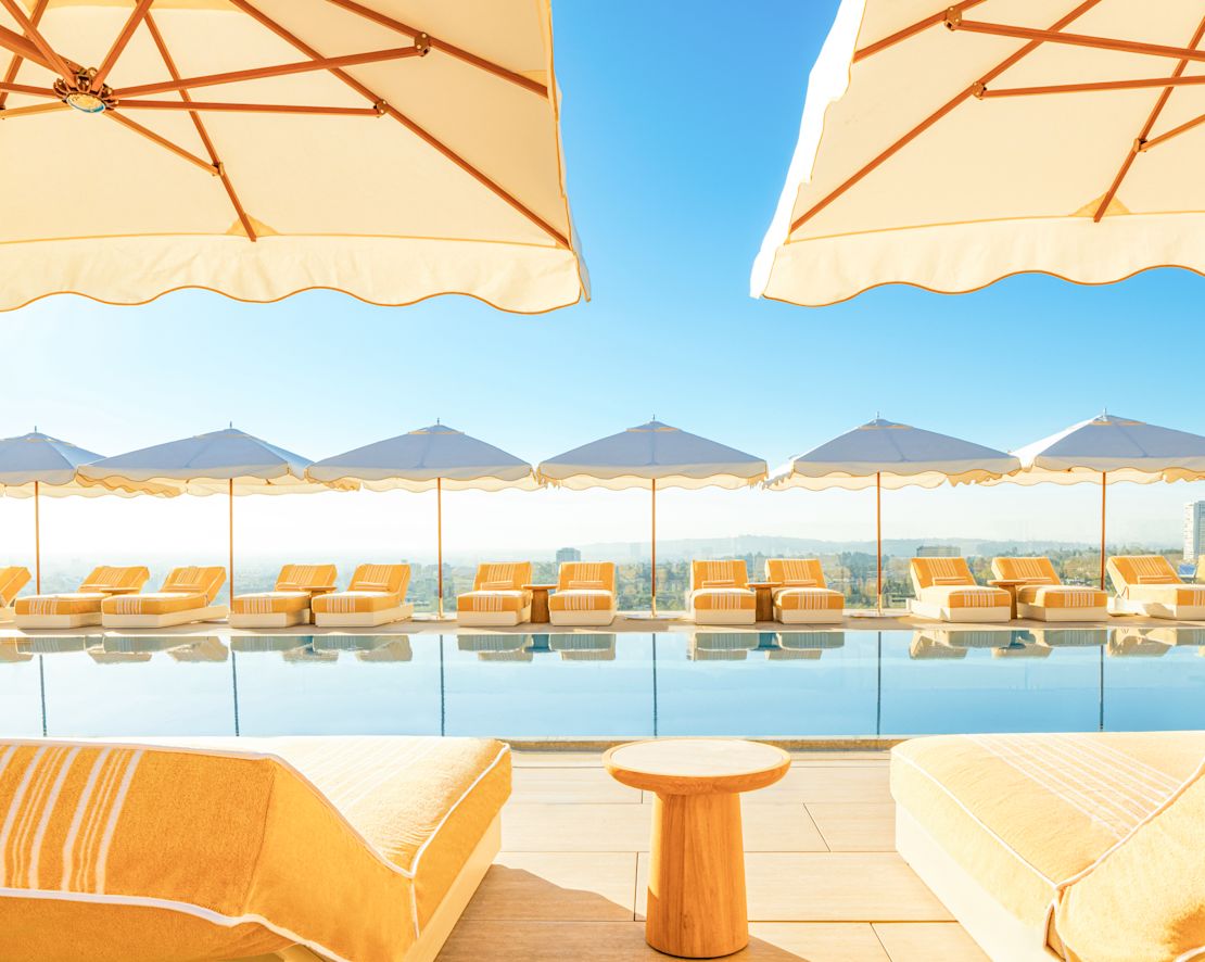 Outdoor Pool Area with Lounge Chairs under Umbrellas-transition