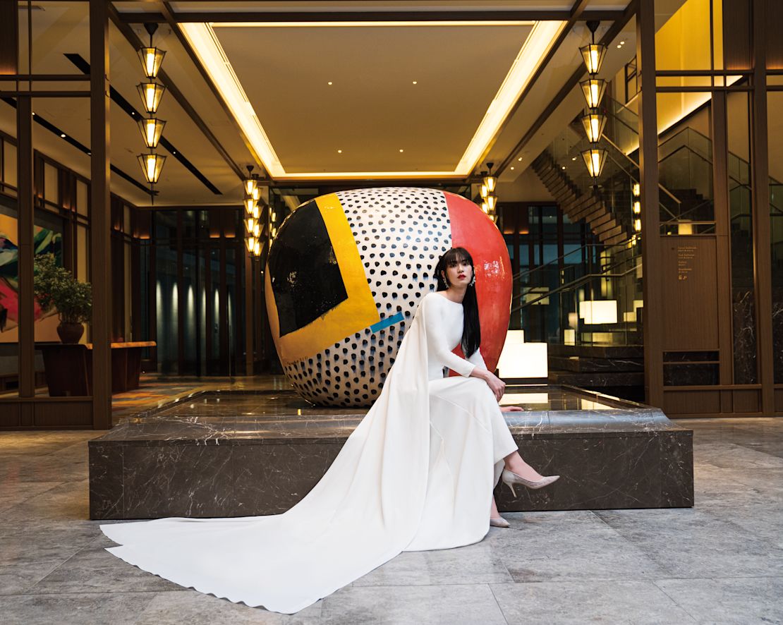 Braut im Kittel vor der Skulptur.-Übergang