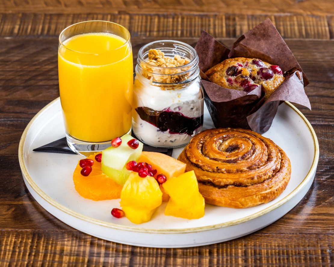 Fresh Fruit Cinnamon Roll Yogurt and Orange Juice for Breakfast at Powder Restaurant-transition