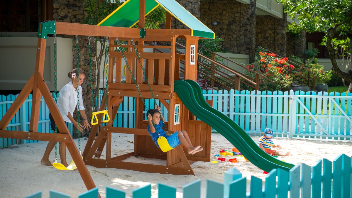Swings and slide on sandy area for kids