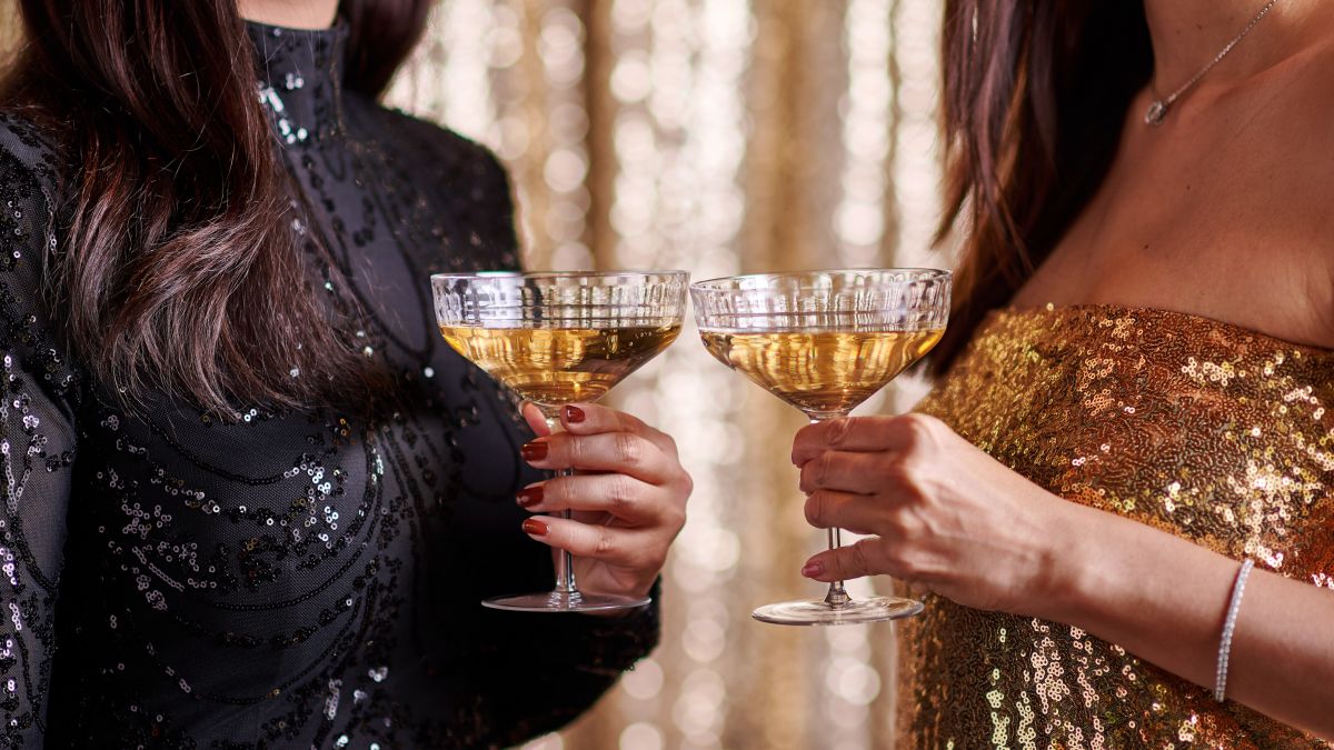 Close-up of people holding champagne
