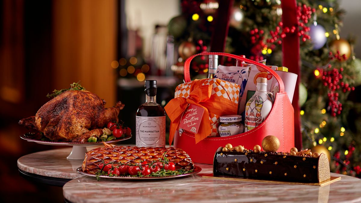 gifts on table with christmas tree in background