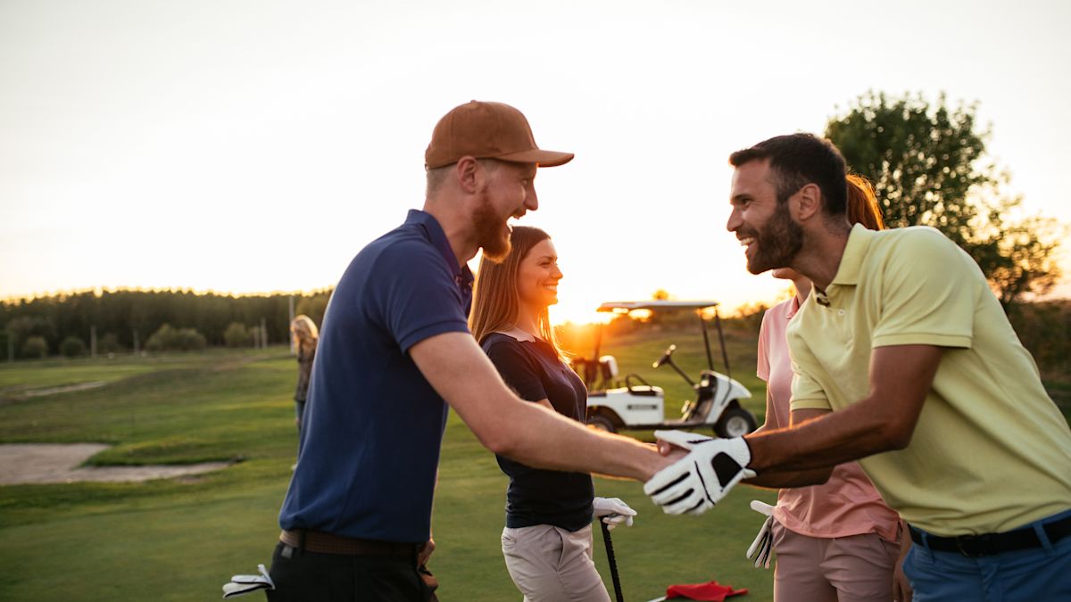 A Group of People Playing Golf on a Team Building Event