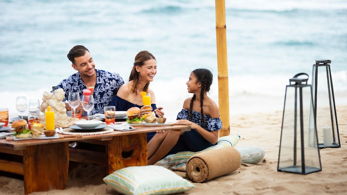 Family at table outside on beach