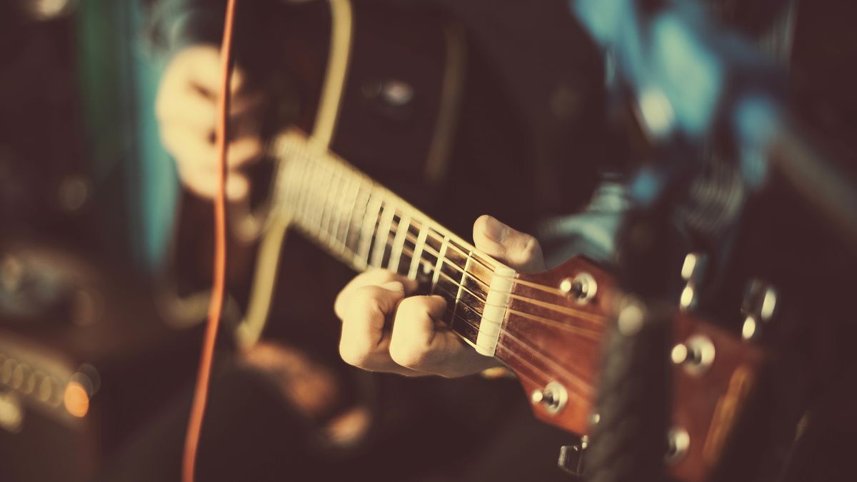 Close up of person playing the guitar