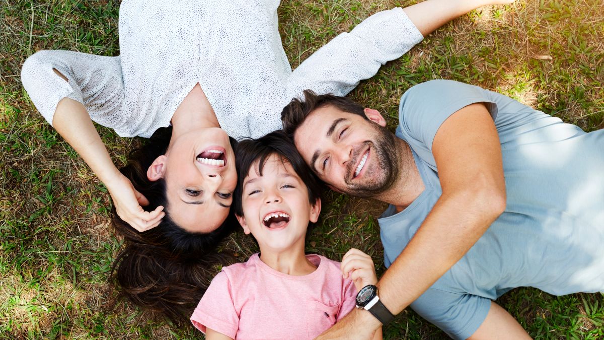 Family smiling together in park