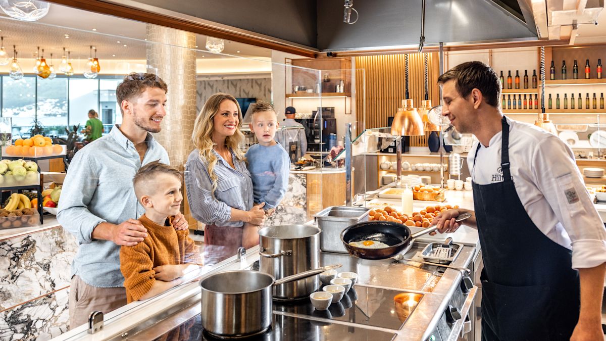 Family at chef station with chef cooking