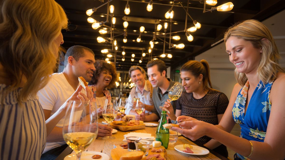 Group of People Eating at a Long Table