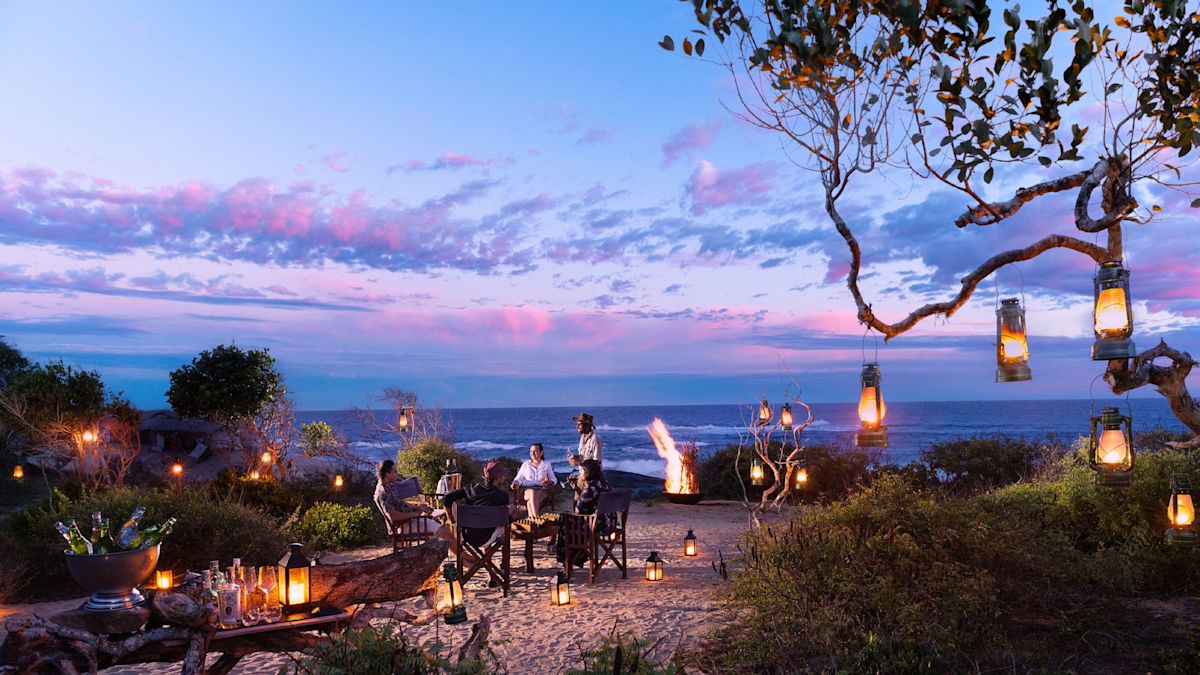 Couple Having Dinner on the Beach at Night