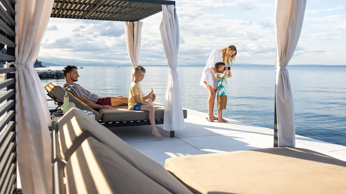 Family relaxing by water
