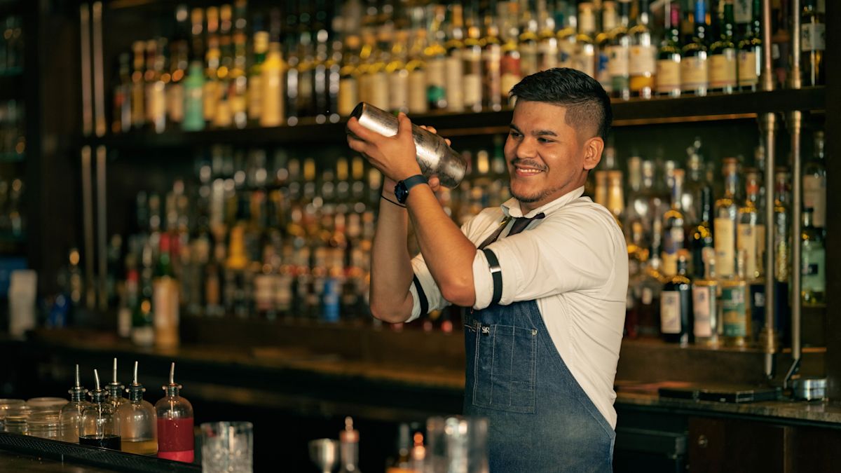 A bartender shaking a cocktail in Sire Bar