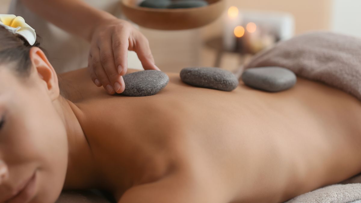 guest receiving a hot stone massage