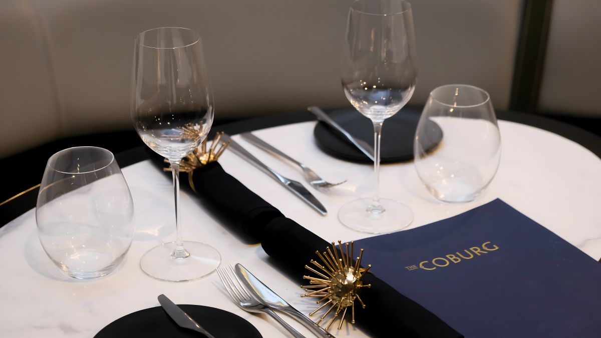 Shot of Coburg table setup with wine glasses and plates
