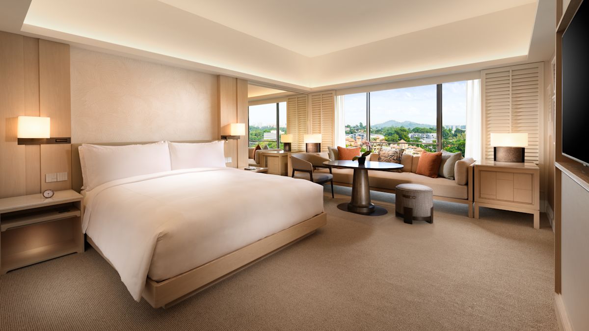 Bed in room with table and chairs