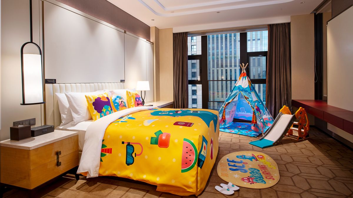 bed in room with children play area