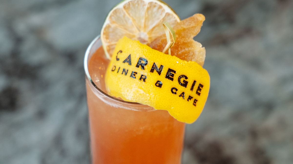 Carnegie Diner & Cafe, glass of  iced tea with a lemon peel with the text Carnegie Diner & Cafe