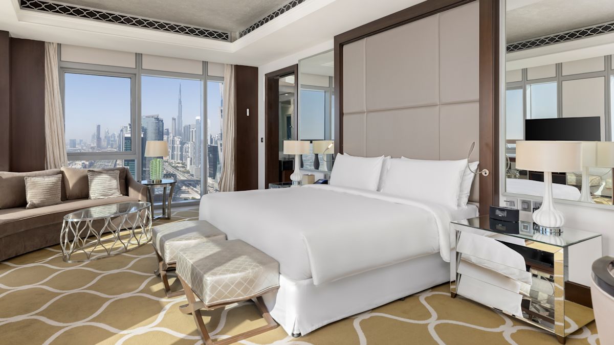 Large Bed and Sofa in a Hotel Suite with City View
